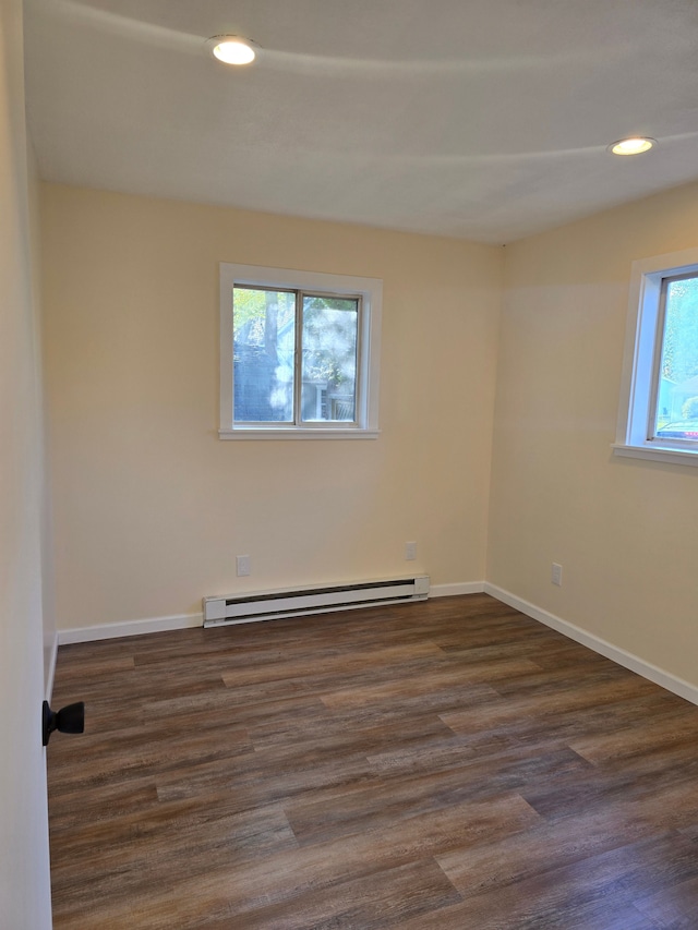 7400 Willow, Lexington, MI 48450 - spare room featuring a baseboard radiator, dark wood finished floors, baseboards, and recessed lighting