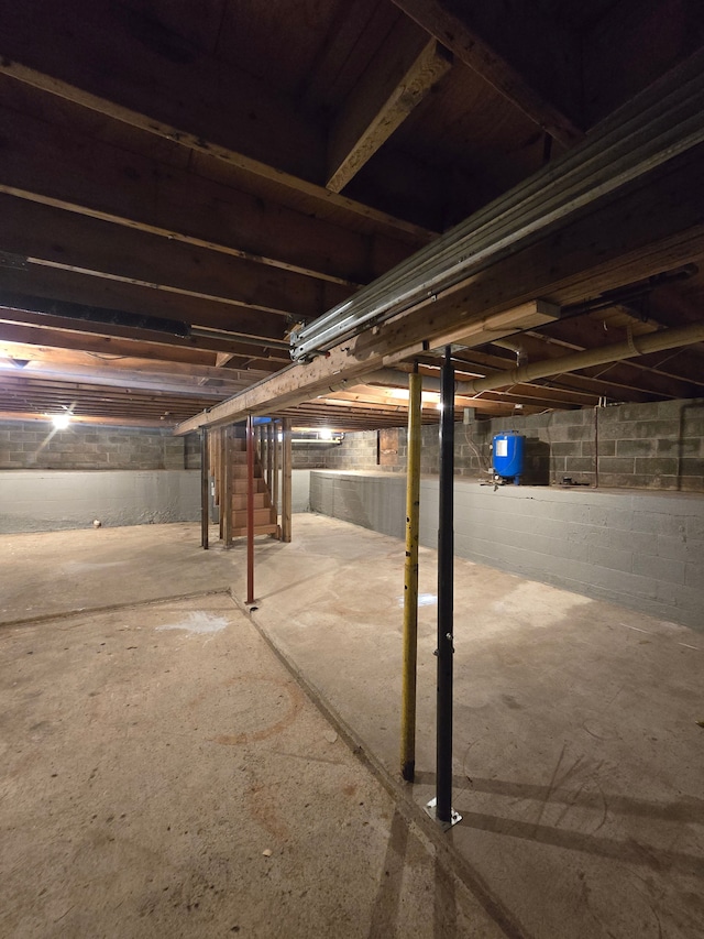 7400 Willow, Lexington, MI 48450 - unfinished basement featuring a water pressure tank and stairway
