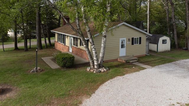 7400 Willow, Lexington, MI 48450 - bungalow with a storage unit, an outdoor structure, a front yard, and driveway