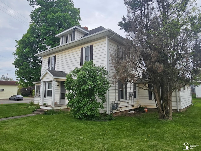view of front of property featuring a front lawn and a chimney
