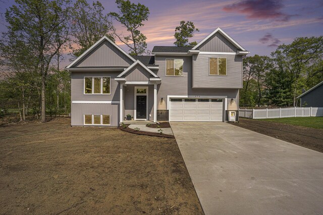 370 Chopin Dr, Muskegon, MI 49442 - view of front of house with an attached garage, driveway, and board and batten siding