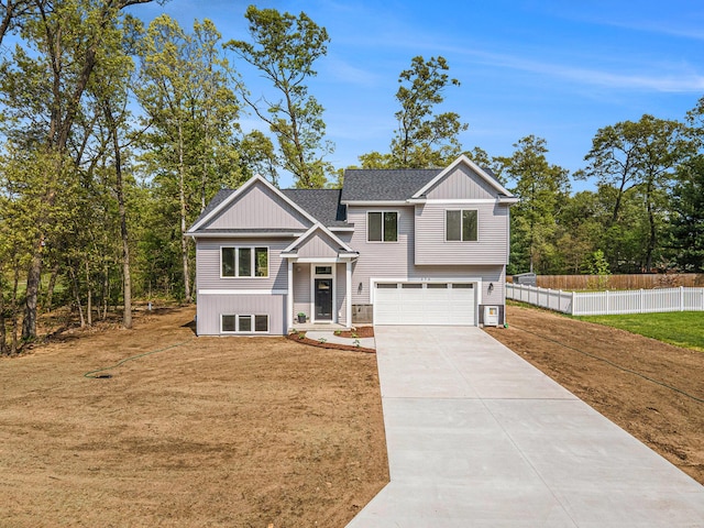 370 Chopin Dr, Muskegon, MI 49442 - view of front of property with a garage, concrete driveway, board and batten siding, and a shingled roof