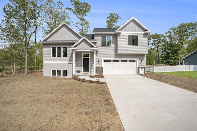 370 Chopin Dr, Muskegon, MI 49442 - view of front of house with an attached garage, fence, driveway, and board and batten siding