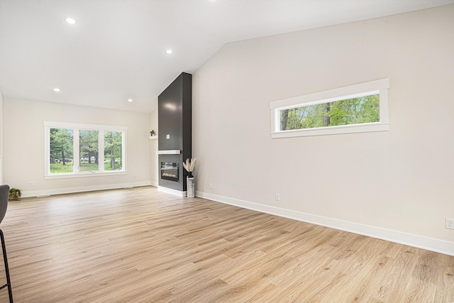 370 Chopin Dr, Muskegon, MI 49442 - unfurnished living room with light wood-style flooring, healthy amount of natural light, baseboards, recessed lighting, and vaulted ceiling