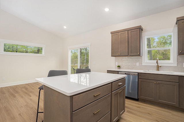 370 Chopin Dr, Muskegon, MI 49442 - kitchen with dishwasher, a sink, a kitchen breakfast bar, plenty of natural light, and vaulted ceiling