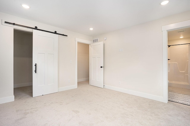 370 Chopin Dr, Muskegon, MI 49442 - unfurnished bedroom with a barn door, carpet, recessed lighting, and baseboards