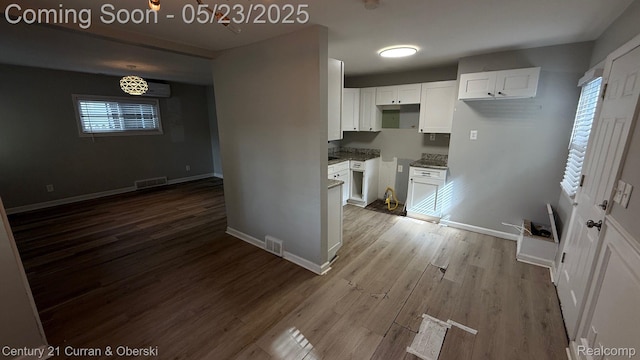 648 W Hazelhurst St, Ferndale, MI 48220 - kitchen featuring wood finished floors, white cabinetry, baseboards, and stone countertops