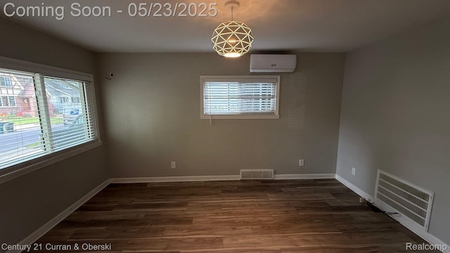 648 W Hazelhurst St, Ferndale, MI 48220 - spare room featuring an AC wall unit, dark wood-style flooring, and baseboards