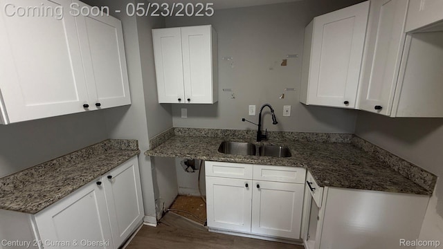648 W Hazelhurst St, Ferndale, MI 48220 - kitchen featuring a sink, white cabinetry, dark wood finished floors, and light stone countertops
