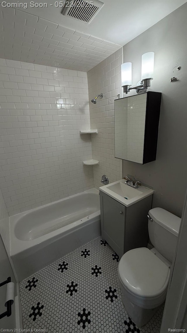 648 W Hazelhurst St, Ferndale, MI 48220 - bathroom with toilet, vanity, tub / shower combination, and tile patterned flooring
