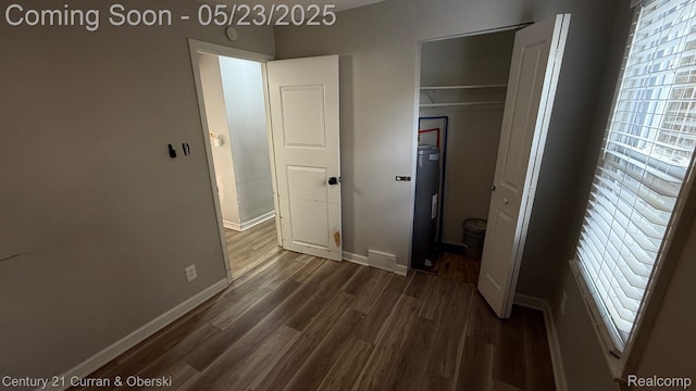 648 W Hazelhurst St, Ferndale, MI 48220 - unfurnished bedroom with dark wood-style flooring, baseboards, and a closet