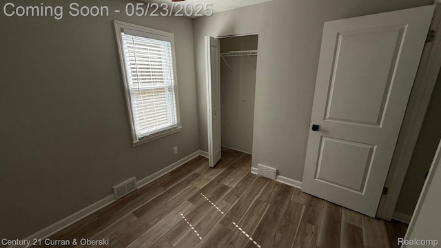 648 W Hazelhurst St, Ferndale, MI 48220 - unfurnished bedroom featuring a closet, wood finished floors, and baseboards
