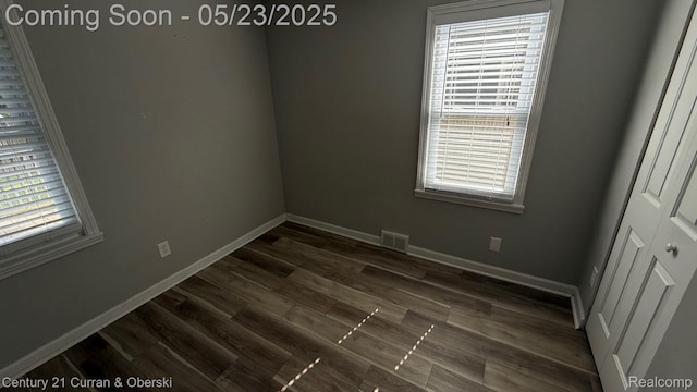 648 W Hazelhurst St, Ferndale, MI 48220 - empty room featuring dark wood-type flooring and baseboards