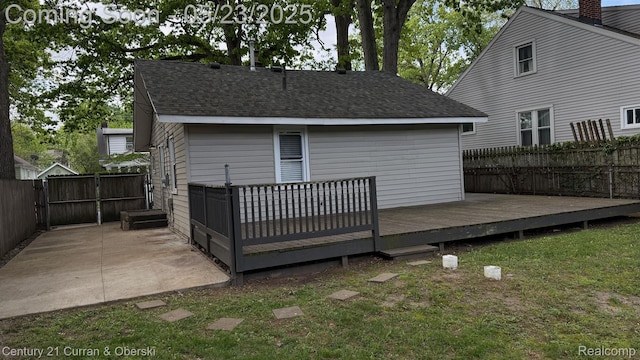 648 W Hazelhurst St, Ferndale, MI 48220 - rear view of property featuring a fenced backyard, a shingled roof, a deck, and a patio