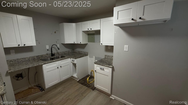 648 W Hazelhurst St, Ferndale, MI 48220 - kitchen featuring a sink, dark wood-type flooring, light stone counters, and white cabinets