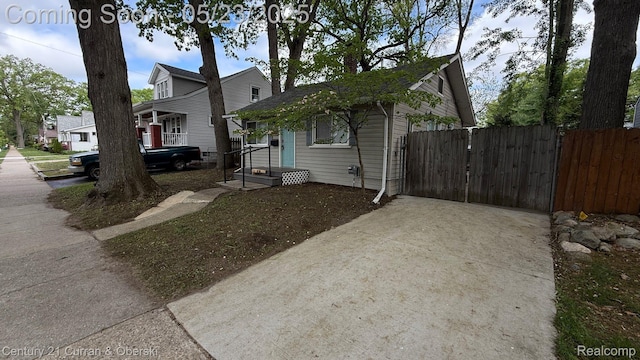 648 W Hazelhurst St, Ferndale, MI 48220 - view of home's exterior featuring concrete driveway and a gate