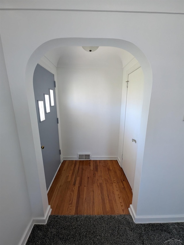 4515 N Michigan Rd, Carrollton, MI 48604 - corridor with arched walkways, wood finished floors, and baseboards