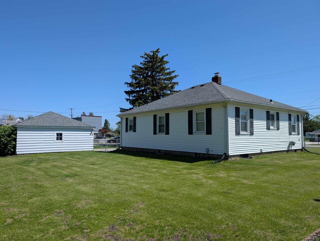4515 N Michigan Rd, Carrollton, MI 48604 - view of side of property featuring a chimney and a shingled roof