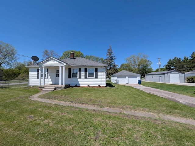 4515 N Michigan Rd, Carrollton, MI 48604 - view of front facade with a garage, a chimney, covered porch, and an outdoor structure