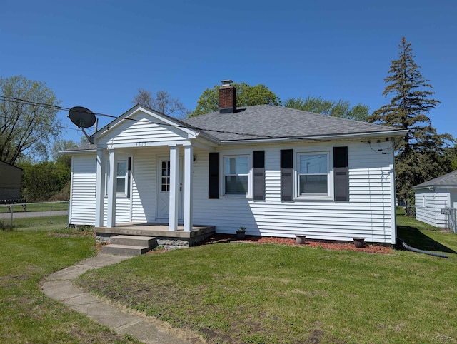 4515 N Michigan Rd, Carrollton, MI 48604 - view of front of house with a chimney, a porch, and a shingled roof