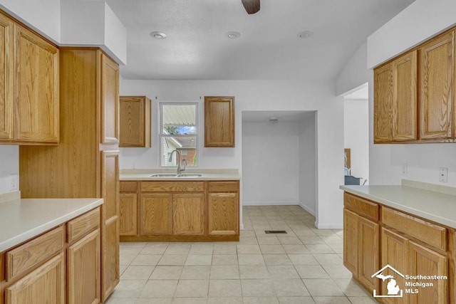 7316 Summerfield Rd, Lambertville, MI 48144 - kitchen featuring a sink, light countertops, light tile patterned floors, and brown cabinets