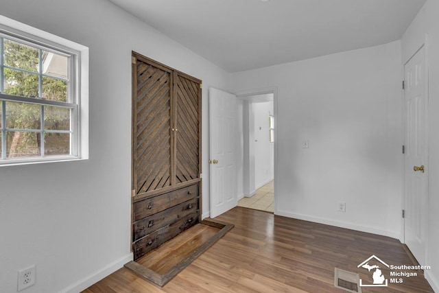 7316 Summerfield Rd, Lambertville, MI 48144 - unfurnished bedroom with wood finished floors and baseboards
