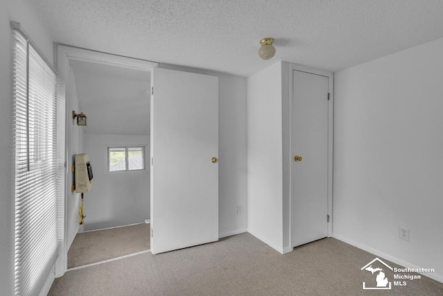 7316 Summerfield Rd, Lambertville, MI 48144 - unfurnished bedroom featuring heating unit, carpet floors, a textured ceiling, and baseboards
