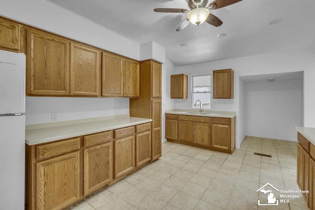 7316 Summerfield Rd, Lambertville, MI 48144 - kitchen featuring freestanding refrigerator, a sink, brown cabinets, and ceiling fan