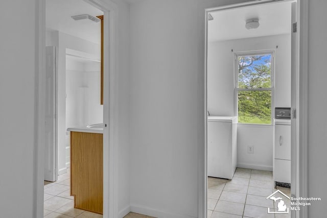 7316 Summerfield Rd, Lambertville, MI 48144 - corridor with light tile patterned floors, washer / dryer, and baseboards