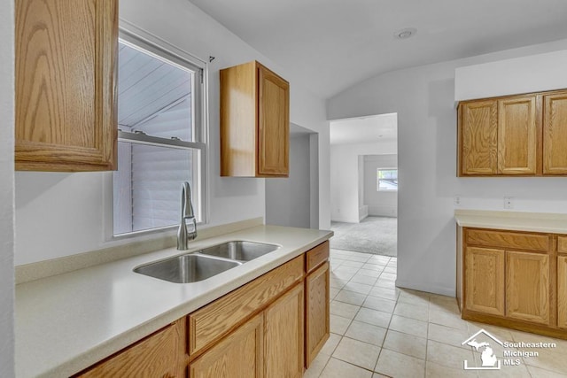 7316 Summerfield Rd, Lambertville, MI 48144 - kitchen with a sink, lofted ceiling, light countertops, light carpet, and light tile patterned flooring