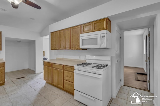 7316 Summerfield Rd, Lambertville, MI 48144 - kitchen with white appliances, light tile patterned floors, a ceiling fan, vaulted ceiling, and light countertops