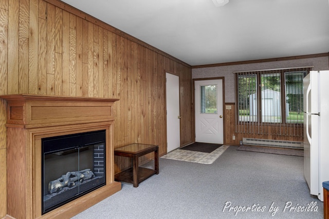 315 Hayes St NW, Comstock Park, MI 49321 - unfurnished living room with a baseboard heating unit, wooden walls, a glass covered fireplace, carpet flooring, and ornamental molding