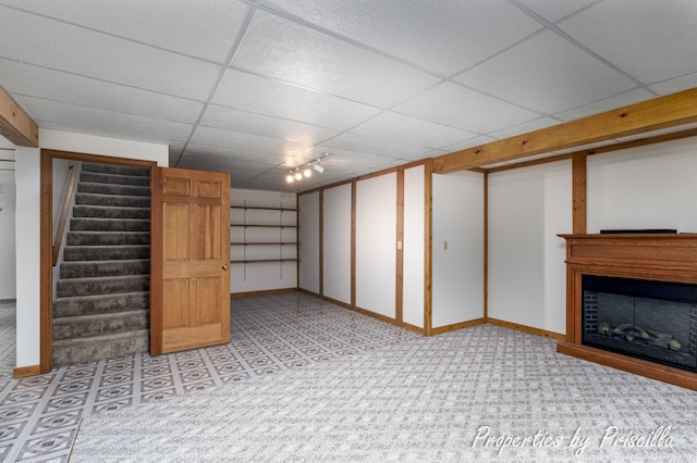 315 Hayes St NW, Comstock Park, MI 49321 - finished basement with baseboards, stairs, a fireplace, a drop ceiling, and carpet floors