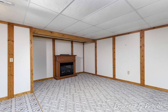 315 Hayes St NW, Comstock Park, MI 49321 - finished basement featuring a drop ceiling, a fireplace, light carpet, and baseboards