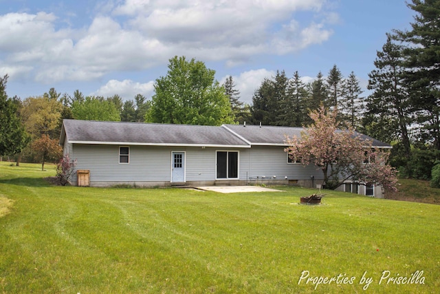 315 Hayes St NW, Comstock Park, MI 49321 - rear view of house featuring a patio, a lawn, and a fire pit