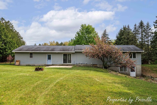 315 Hayes St NW, Comstock Park, MI 49321 - rear view of property featuring a lawn, a patio, and an outdoor fire pit