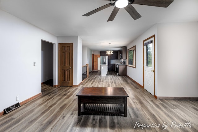 315 Hayes St NW, Comstock Park, MI 49321 - unfurnished living room featuring baseboards, wood finished floors, and a ceiling fan