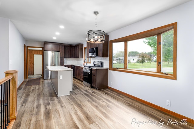315 Hayes St NW, Comstock Park, MI 49321 - kitchen with stainless steel appliances, a sink, light countertops, dark brown cabinetry, and recessed lighting