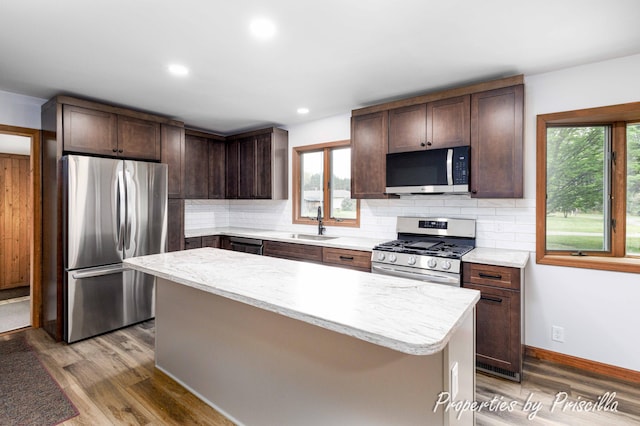 315 Hayes St NW, Comstock Park, MI 49321 - kitchen featuring appliances with stainless steel finishes, a sink, plenty of natural light, wood finished floors, and recessed lighting
