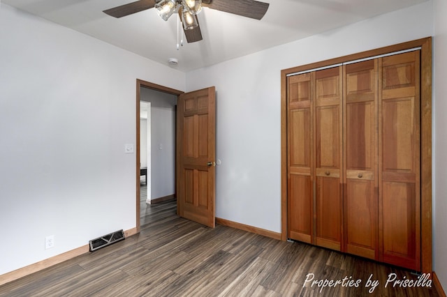 315 Hayes St NW, Comstock Park, MI 49321 - unfurnished bedroom with dark wood finished floors, baseboards, a closet, and a ceiling fan