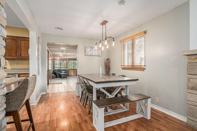 1514 Ferndale Blvd, Niles, MI 49120 - dining space featuring a stone fireplace, light wood-style flooring, and baseboards