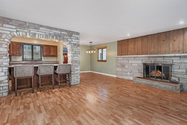 1514 Ferndale Blvd, Niles, MI 49120 - kitchen featuring decorative columns, light wood-style flooring, a breakfast bar, open floor plan, and recessed lighting