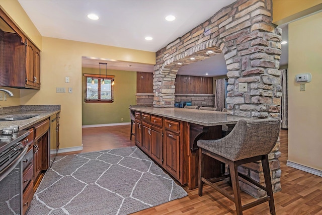1514 Ferndale Blvd, Niles, MI 49120 - kitchen with a sink, decorative columns, dark wood finished floors, baseboards, and stainless steel electric stove