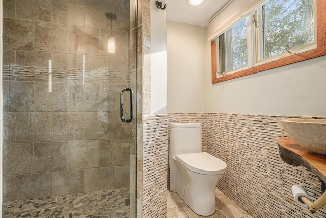 1514 Ferndale Blvd, Niles, MI 49120 - bathroom with tile walls, a stall shower, tile patterned flooring, toilet, and a wainscoted wall