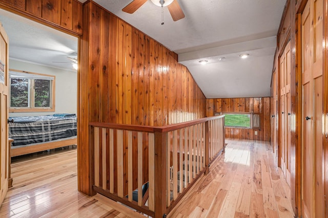 1514 Ferndale Blvd, Niles, MI 49120 - hallway with wood walls, light wood-type flooring, an upstairs landing, and vaulted ceiling