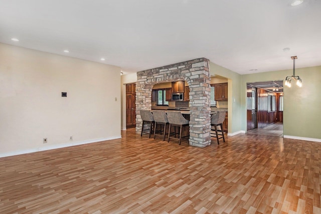 1514 Ferndale Blvd, Niles, MI 49120 - unfurnished living room with light wood-style floors, baseboards, and recessed lighting