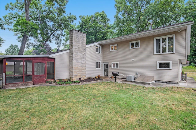 1514 Ferndale Blvd, Niles, MI 49120 - back of property featuring a sunroom, central AC, a yard, and a chimney