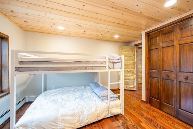 2220 Grass Lake Ave, Lake, MI 48632 - bedroom with wood ceiling, wood finished floors, recessed lighting, a baseboard heating unit, and a closet