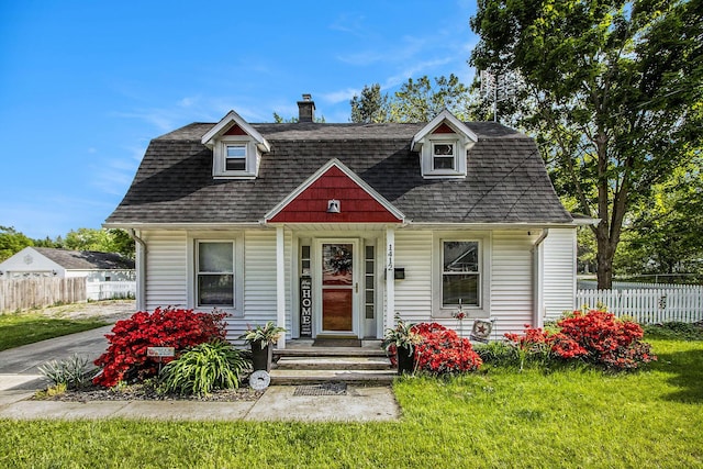 view of front of home with a chimney and a shingled roof