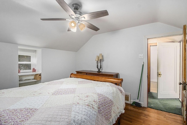 bedroom featuring wood finished floors, vaulted ceiling, and ceiling fan